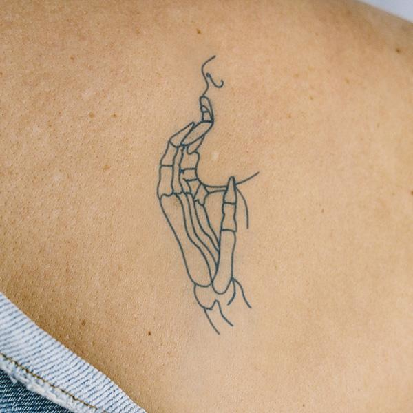 Skelekissy by Curt Montgomery is a temporary tattoo from inkbox - 0